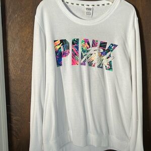 Ladies Pink sweatshirt. Size Large. White with multi color letters.